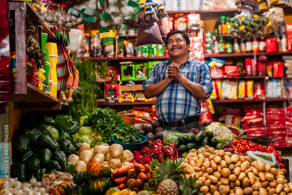  Grocery store in Guatemala and a happy man with his hands in a praying position.