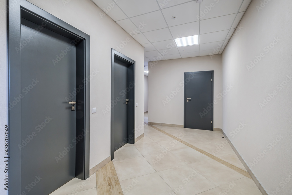 long white empty corridor in interior of entrance hall of modern apartments, office or clinic long white empty corridor in interior of entrance hall of modern apartments, office or clinic