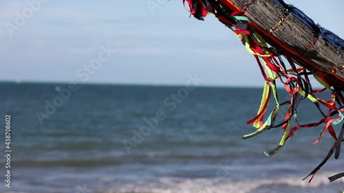 DETAIL OF HAMMOCK SWINGING WITH WIND MOVEMENT FROM THE COAST OF CEARA WITH THE SEA IN THE BACKGROUND photo