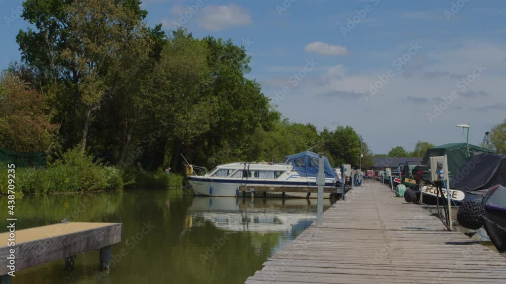 Canal boats along a marina jetty in England Canal boats along a marina jetty in England