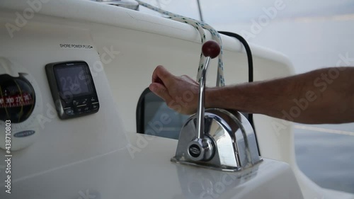 Close up footage of a man pulling the lever on a sailing yacht up photo