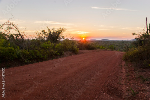 red dirt road at sunset