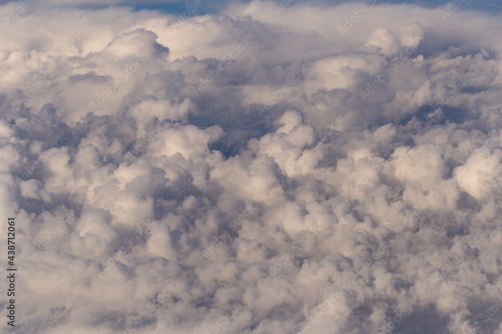 Stratosphere, a view of clouds from an airplane window. Cumuliform cloudscape on sky. Flying over the land. Stratosphere, a view of clouds from an airplane window. Cumuliform cloudscape on sky. Flying over the land.