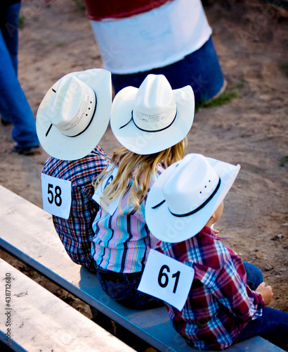 The young cowboys on the bench waiting to ride during adventures of The West in Robertson, Wyoming and the ranches in the Bridger Valley.  photo