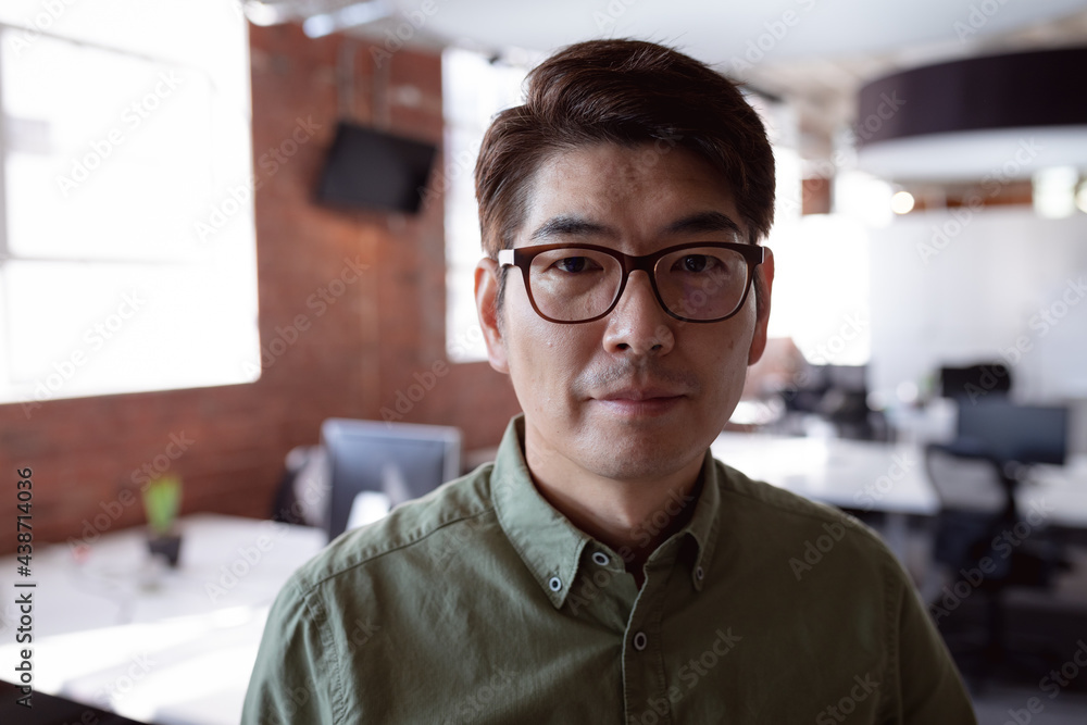 Fototapeta premium Portrait of serious asian businessman standing in office looking to camera