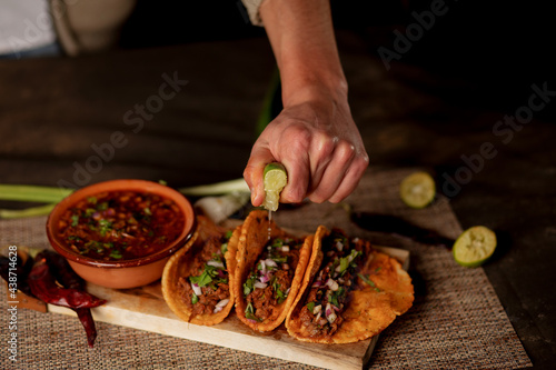 tabla preparada con birria y barbacoa lista para comer en tacos photo
