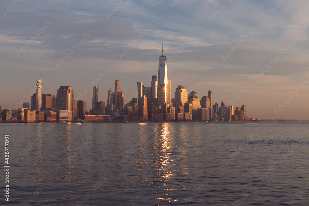 Beautiful Lower Manhattan Skyline Shining in the Sun during a Sunset in New York City along the Hudson River Beautiful Lower Manhattan Skyline Shining in the Sun during a Sunset in New York City along the Hudson River