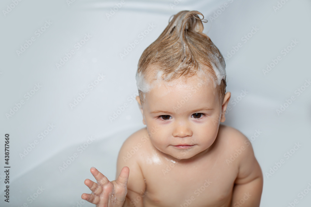 Todler in shower. Kid in bathtub with fluffy soap bubble. Happy baby taking a bath playing with foam bubbles. Little child in a bathtub. Infant washing and bathing. Kids care and hygiene. Todler in shower. Kid in bathtub with fluffy soap bubble. Happy baby taking a bath playing with foam bubbles. Little child in a bathtub. Infant washing and bathing. Kids care and hygiene.