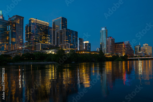 Downtown Skyline of Austin  Texas in USA from view at sunset. Reflection in water.