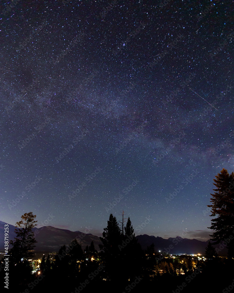 Milky Way with starry night sky over town
