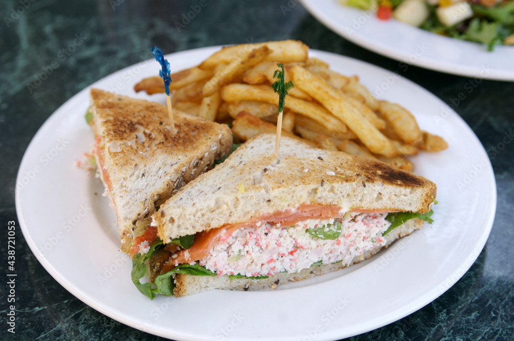 Grilled crab sandwich with french fries.