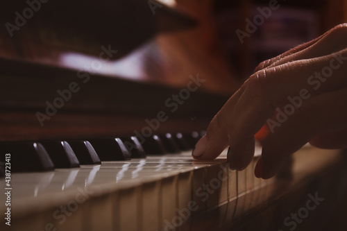 Woman playing piano. Close-up. Fingers on keys.
