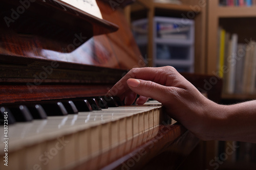 Girl and piano at home. Selective focus.