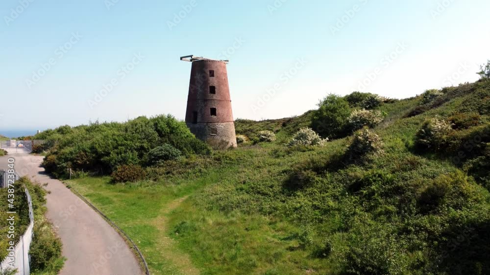 Amlwch port red brick disused abandoned windmill aerial view North Anglesey Wales rising from pathway Amlwch port red brick disused abandoned windmill aerial view North Anglesey Wales rising from pathway