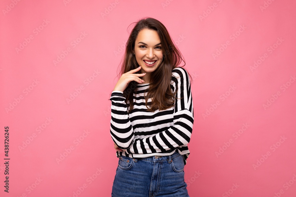 Portrait of positive cheerful fashionable woman in casual clothes isolated on pink background with copy space Portrait of positive cheerful fashionable woman in casual clothes isolated on pink background with copy space