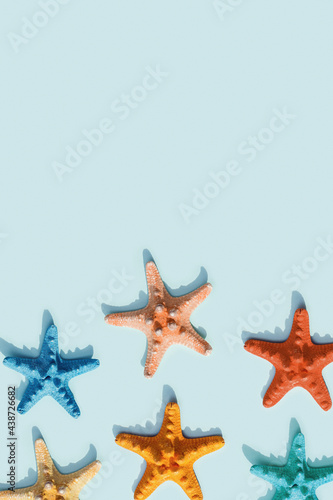 Nautic scene with colorful sea stars. Happy, bright and summer mood flat lay.