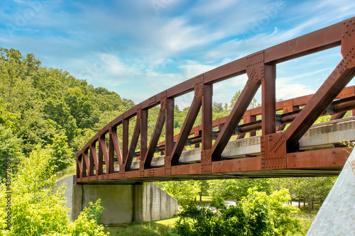 Metal steadfast vehicular truss bridge over small river