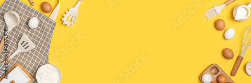 Banner made with baking ingredients and cooking utensil with copy space on yellow background. Template for your cooking design. Top view Flat lay Copy space