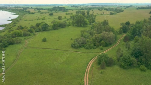 Panoramic View Of The Vast Green Meadow With A Walking Trail In Rambynas Regional Park. aerial photo