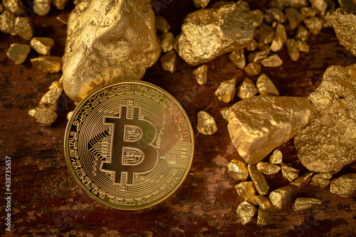 Gold bitcoin physical Bitcoin-Cryptocurrency and Gold nugget grains. Business concept