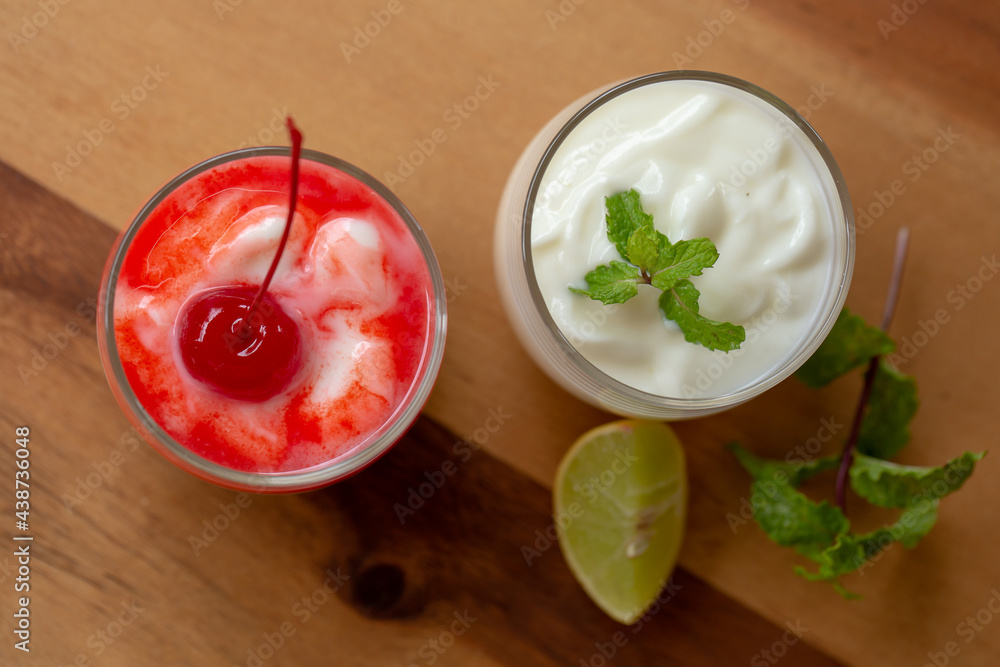 Glass of Cherry yogurt on a brown wood table Glass of Cherry yogurt on a brown wood table