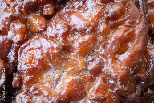 Macro close up of texture of an apple fritter pastry for breakfast at the donut shop photo