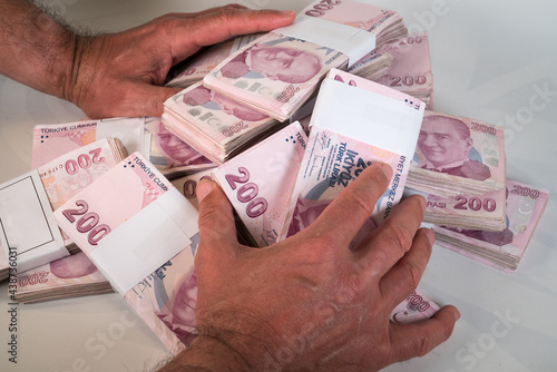 Hands holding 200 Lira banknote Turkish money (Turk Parasi). photo