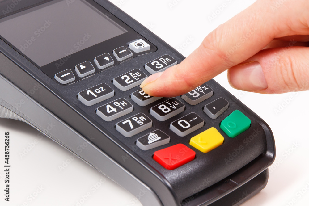 Hand of woman entering PIN code on payment terminal. Cashless paying for shopping. Finance concept Hand of woman entering PIN code on payment terminal. Cashless paying for shopping. Finance concept