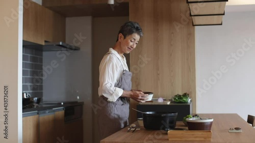 料理を盛り付ける日本人シニア女性