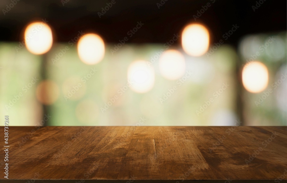 Empty wooden table in front of abstract blurred background of coffee shop . can be used for display Mock up  of product