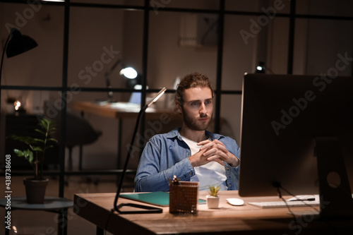 Handsome man working in off...