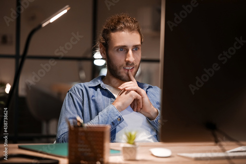 Handsome man working in off...