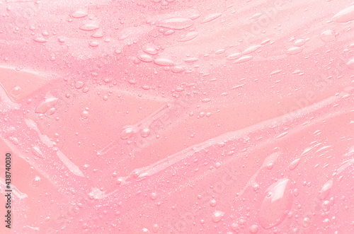 Fotografie Tender pastel pink slime background with gold glitter glowing and drip lines, top view