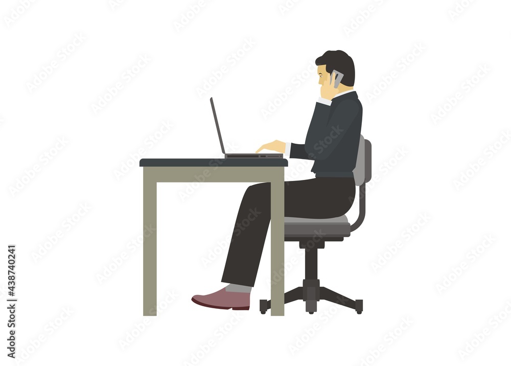 Male employee having a conversation by phone while typing on a laptop.