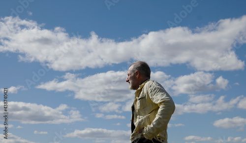 Man looking at the sky on a cloudy day