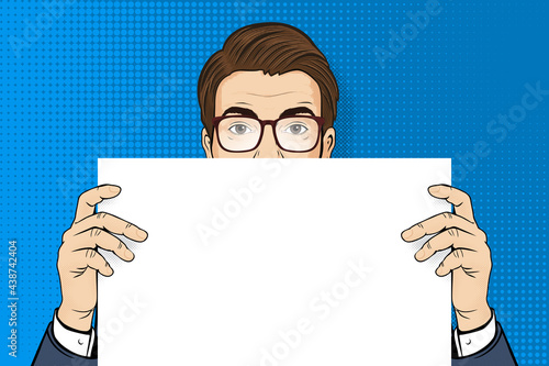 Pop art man. Man in glasses holding white paper. Retro halftone background in comic style with open space. Stock vector illustration for invitation poster or design.