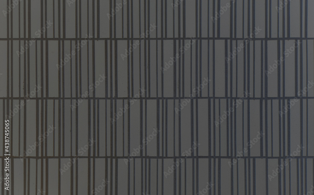 Dark gray pottery brick tile wall texture with black joint. Building exterior or interior design material background Dark gray pottery brick tile wall texture with black joint. Building exterior or interior design material background