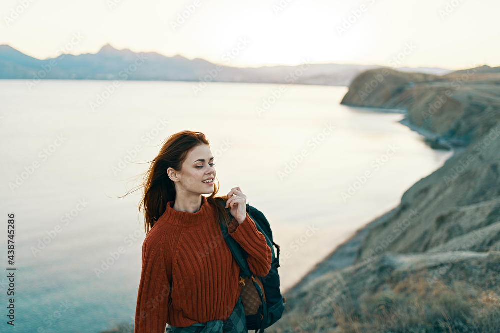 traveler high in the mountains near the sea in nature Adventure joy emotions