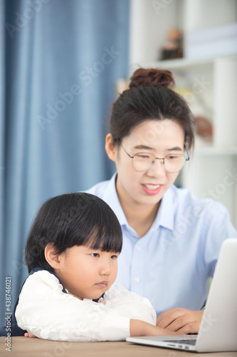 Mother accompanies her child to computer study 