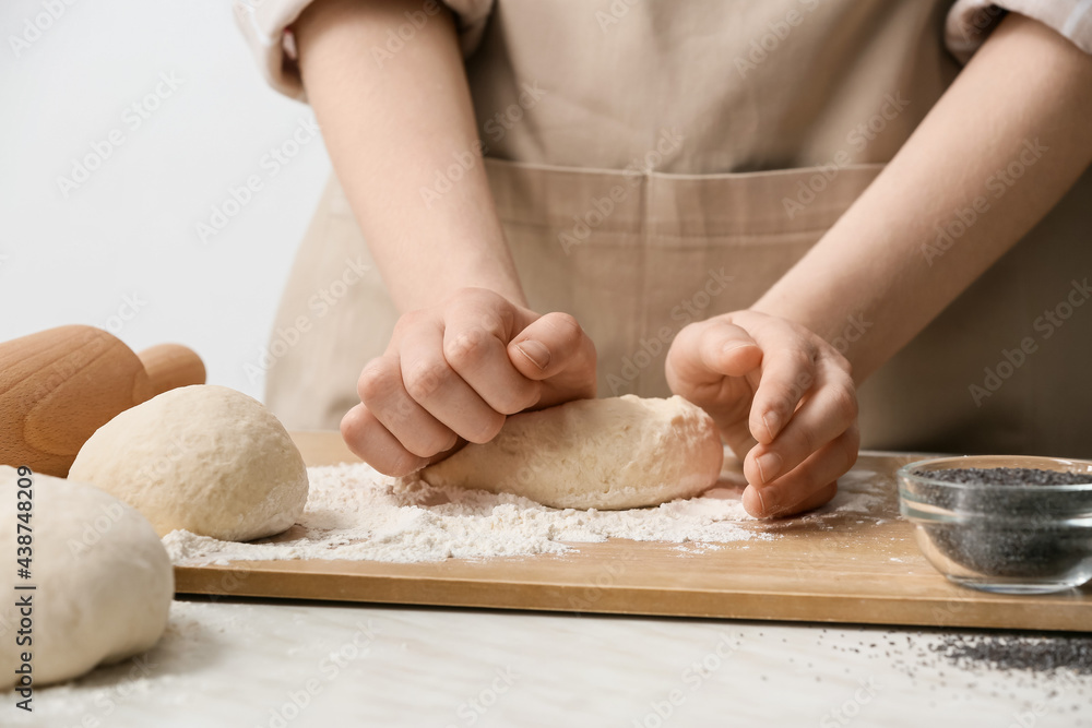 Female chef preparing dough on kitchen table, closeup Female chef preparing dough on kitchen table, closeup