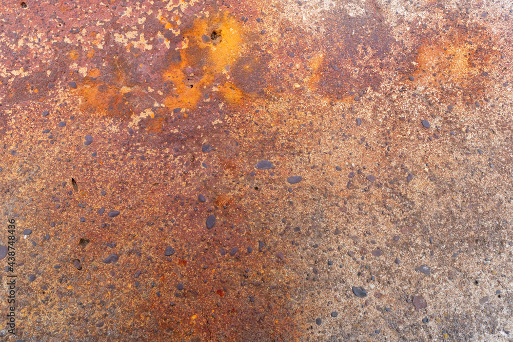 Rusty concrete surface. Stones, spots.