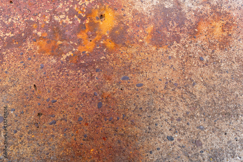 Rusty concrete surface. Stones, spots.