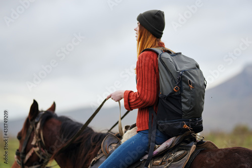 woman hiker with backpack riding horse travel freedom