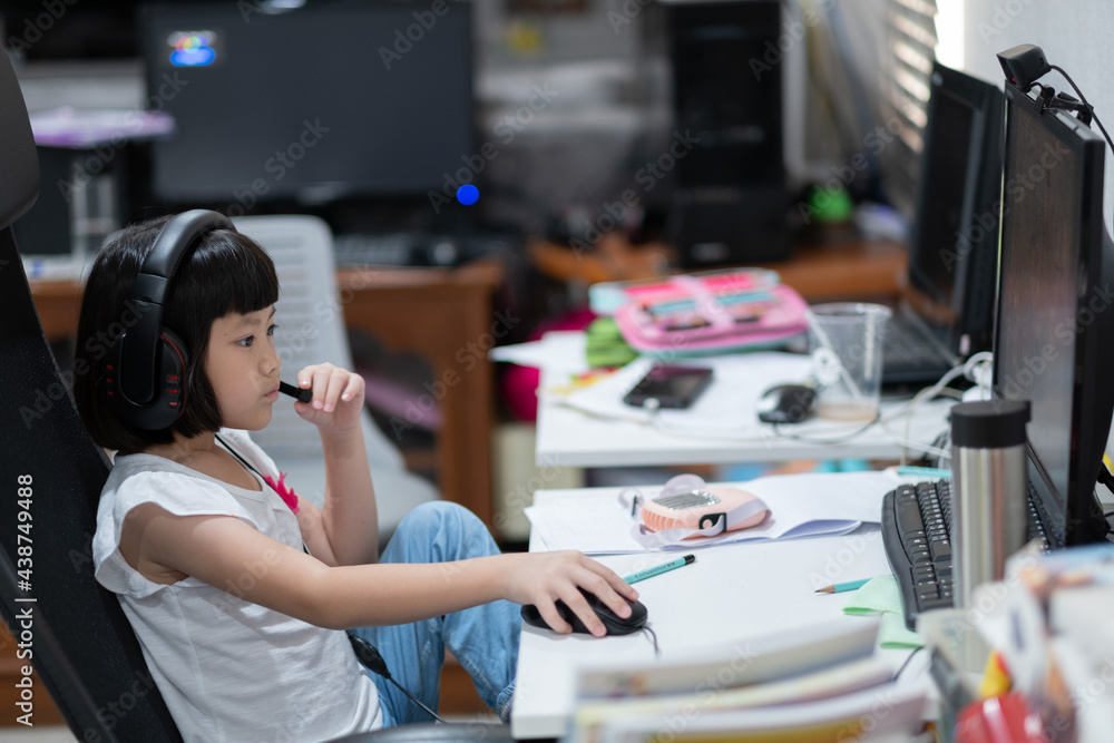 Asian children is learning online computer, home school