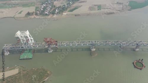 Aerial view of a building site while assembling the Padma bridge, the longest rail and highway bridge in Bangladesh crossing the Padma river, Zajira, Dhaka, Bangladesh. photo