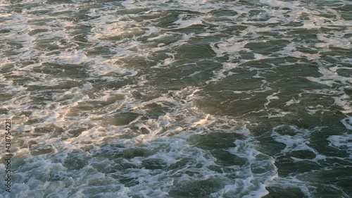 4k video from above waves with sea foam near the shore