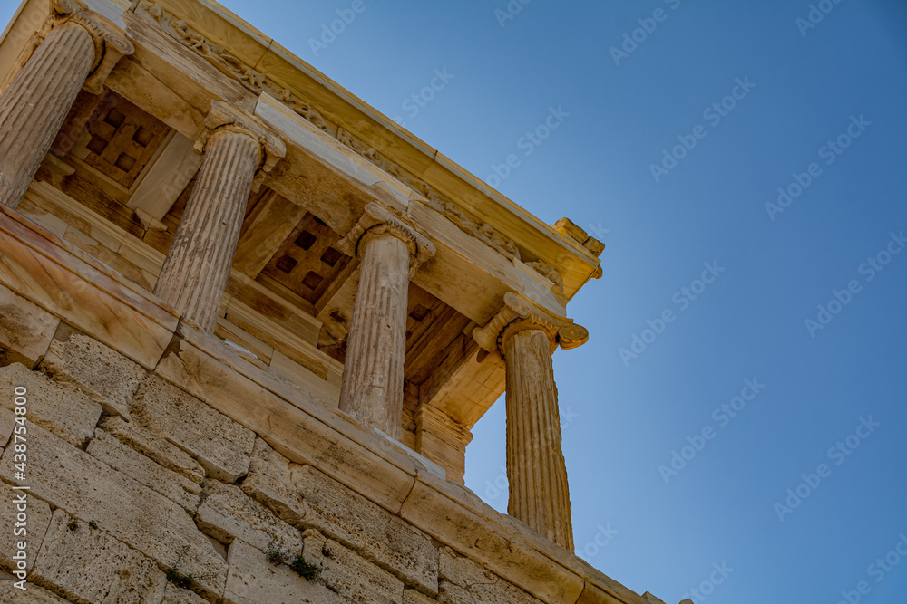 Fototapeta premium Low angle view of the front of the Athena Nike Temple with ancient columns on the Acropolis in Athens, Greece