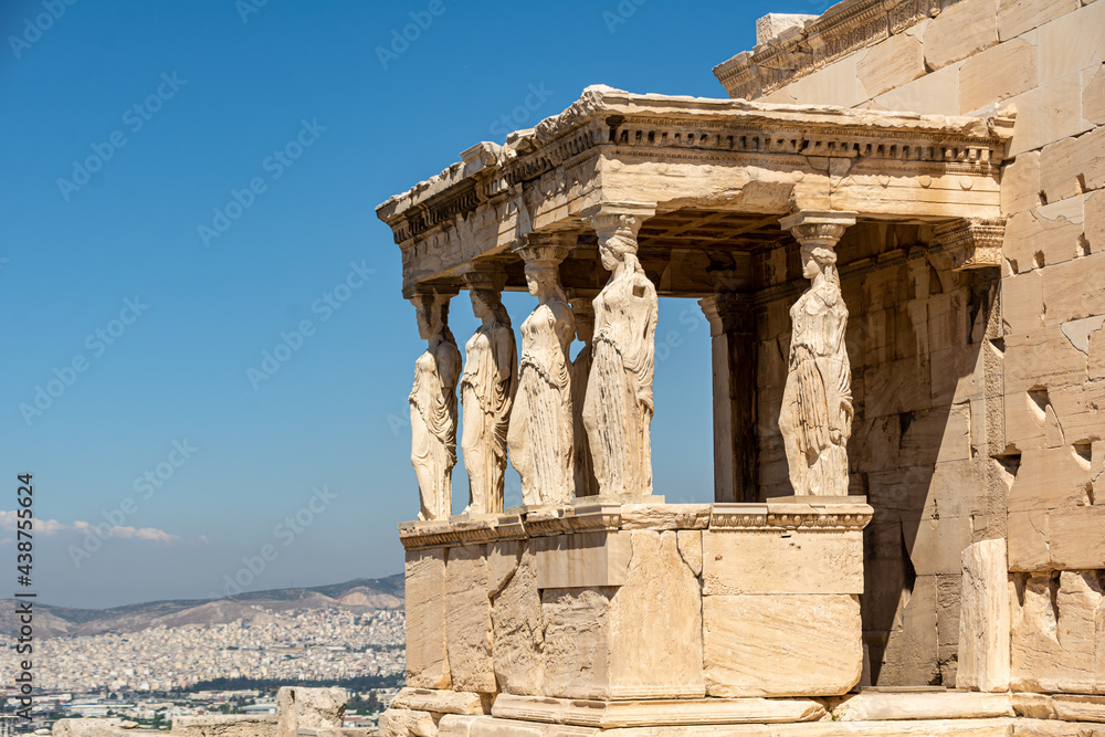 Acropolis in Athens, Greece. View of the Figures of the Caryatid Porches of Erechtheion against a blue sky