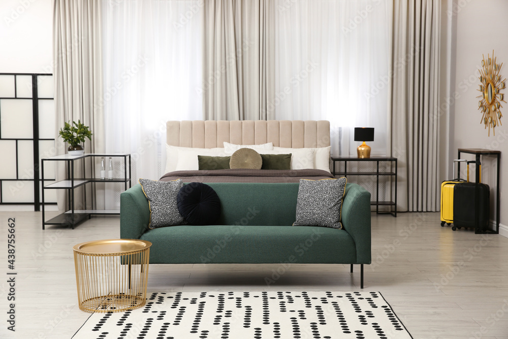 Naklejka premium Beautiful hotel room interior with green sofa