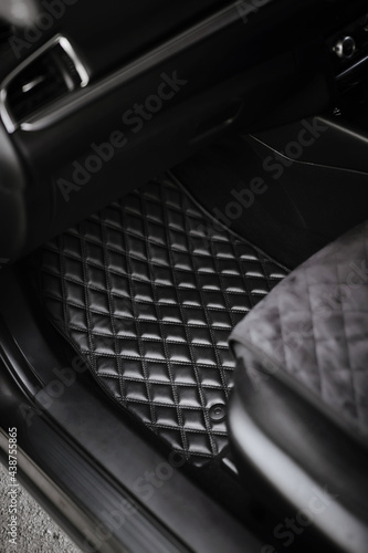 leather floor mat with diamond shape texture. eco leather luxury floor mat on the front row car interior.